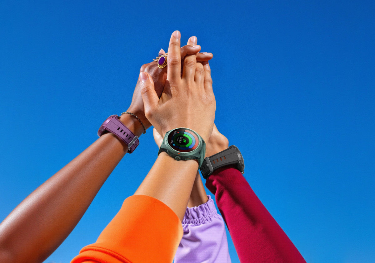 Friends raising their wrists together, wearing Runmefit watches